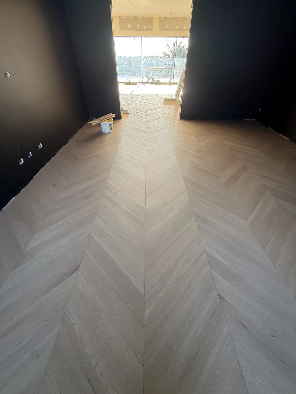 Precision chevron flooring centre line in a Sydney residence